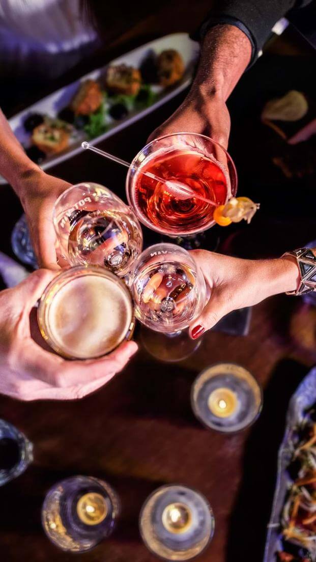 Meal with friends at a restaurant, with plenty of alcohol and food.