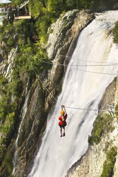 The zip line at Parc de la Chute-Montmorency with the waterfall in the background.